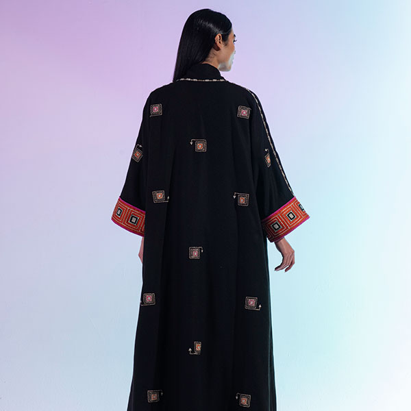 An abaya made of velvet material decorated with hand embroidery ...